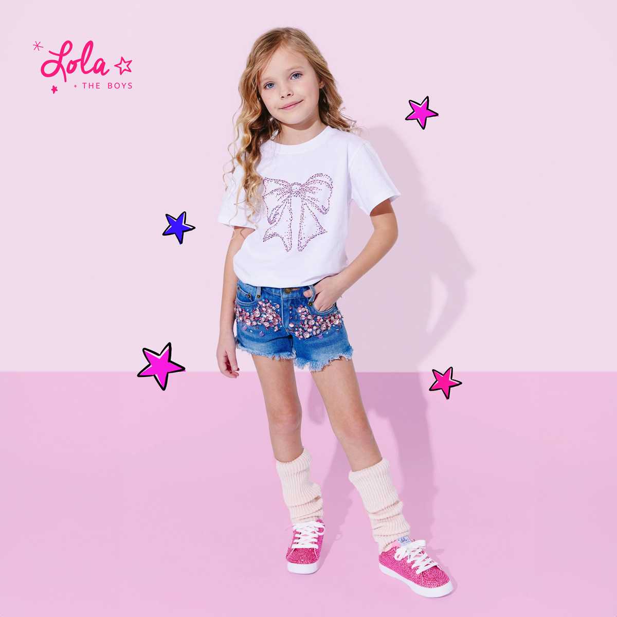 Stylish girl wearing kids’ denim shorts with a cozy jacket and boots