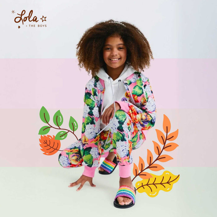 Kids wearing colorful spring floral outfits with bright seasonal patterns outdoors