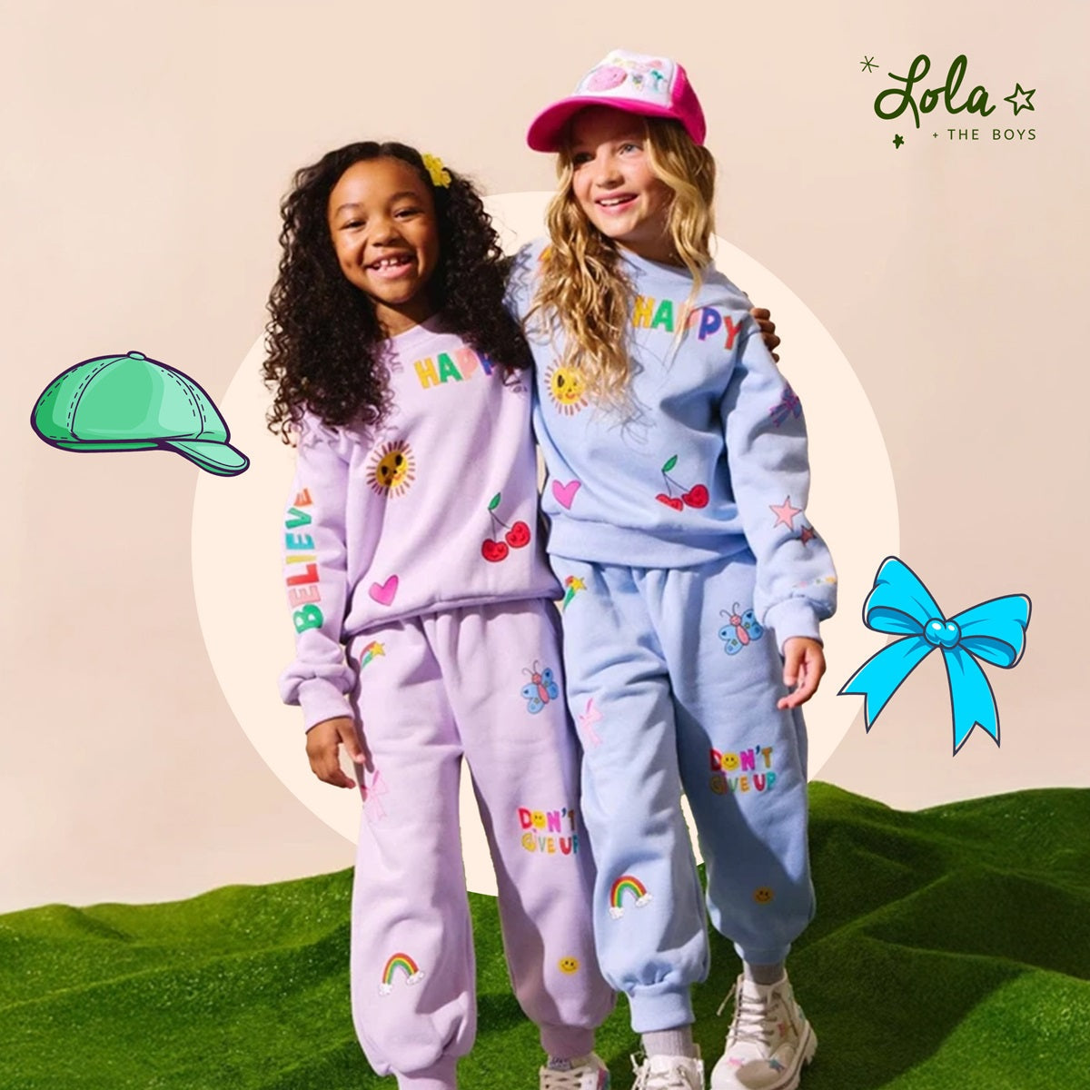 A young girl smiling and posing in a colorful, sequin-embellished Lola + the Boys dress. The text reads 