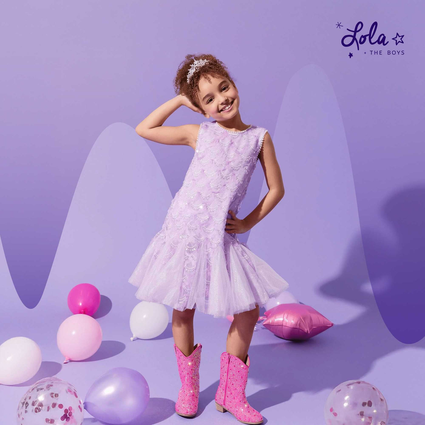 Kids posing in Halloween photo booth wearing affordable kids clothes with sparkly props and backdrops